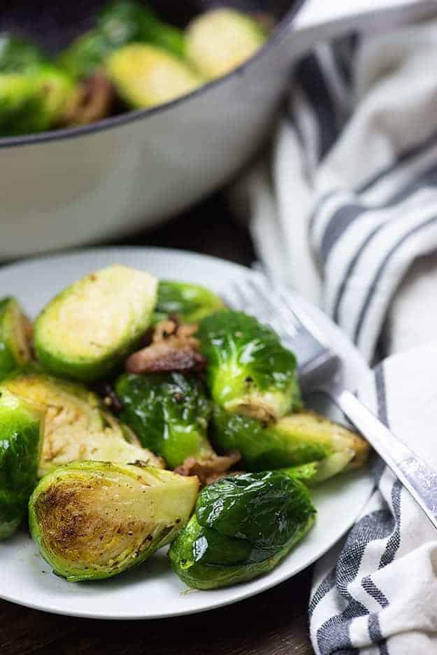 brussels sprouts on white plate with fork and towel