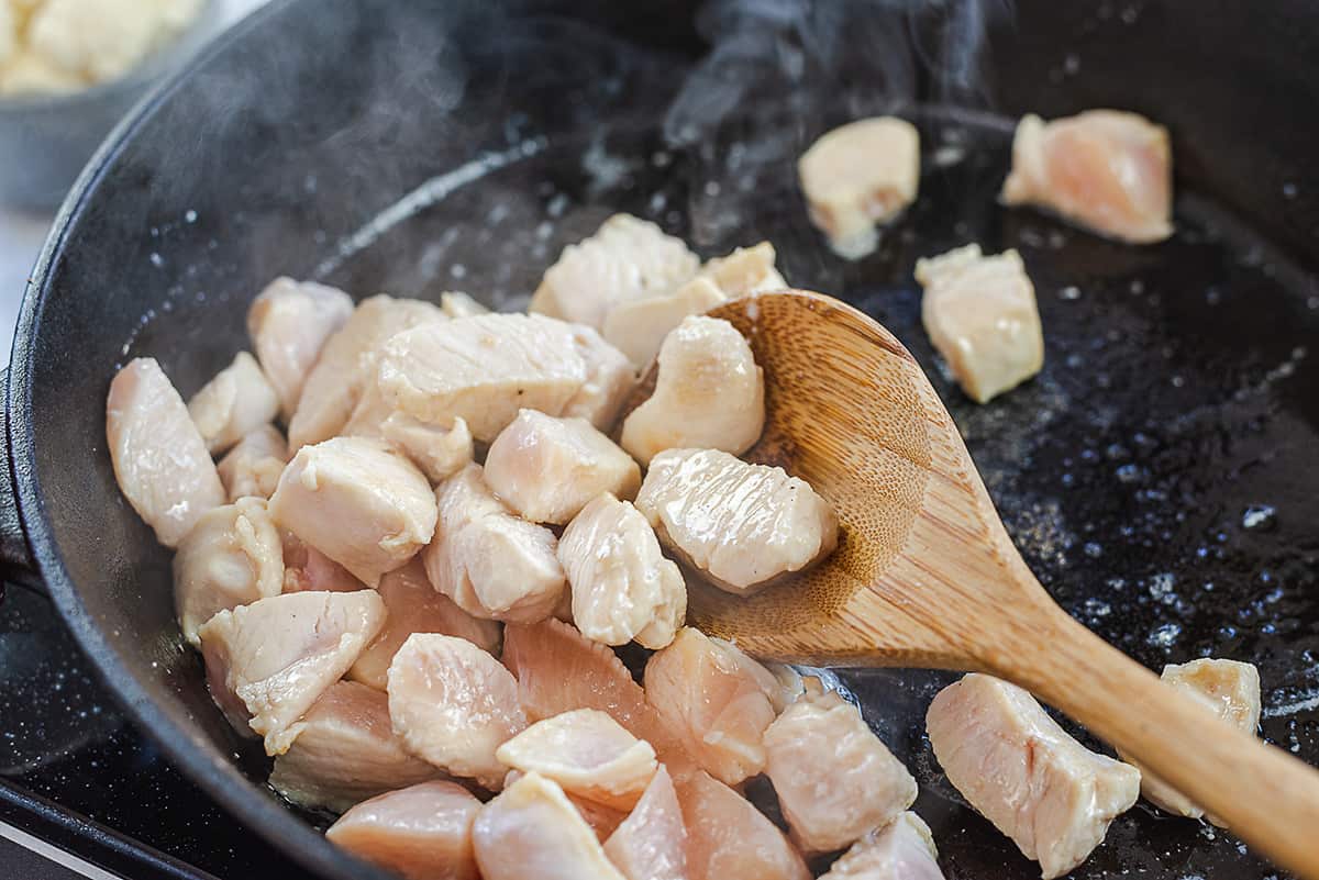 chicken cooking in skillet.