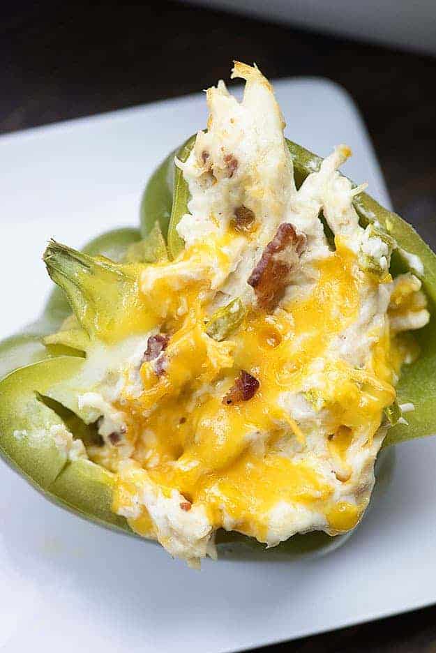 low carb stuffed peppers with cheddar and bacon on white plate