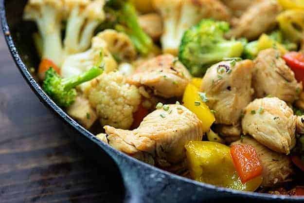 Zoomed in shot of cooked chicken stir fry in a skillet.