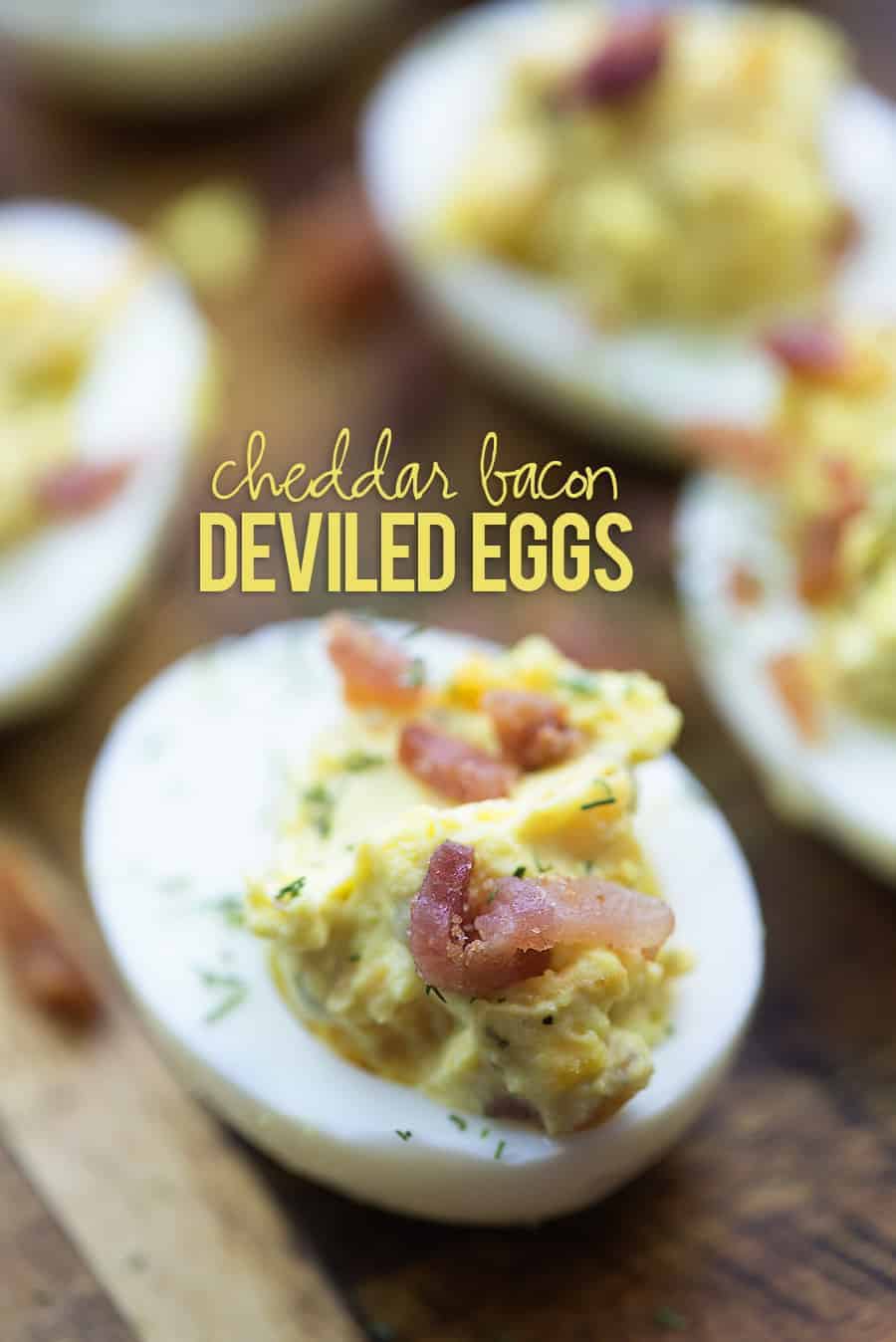 deviled eggs with bacon on cutting board