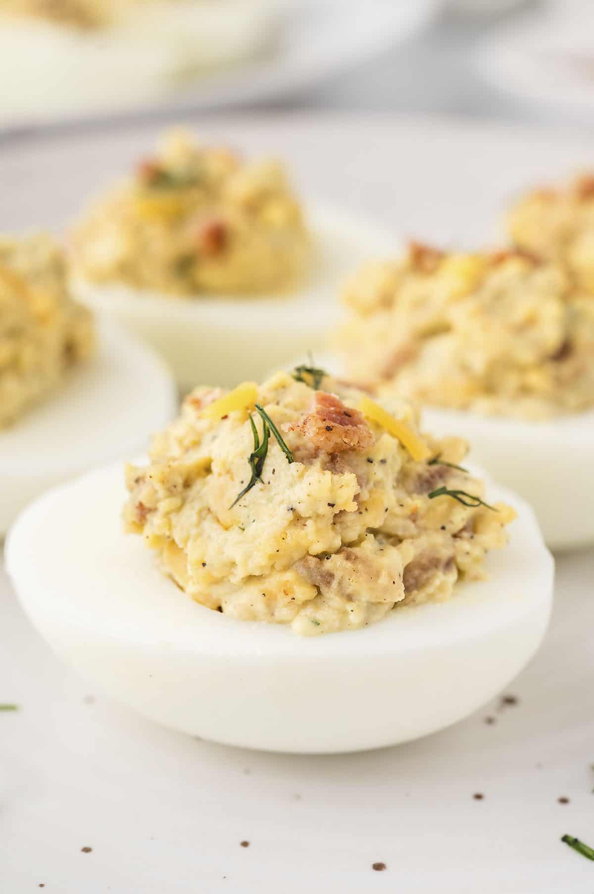 Devilled eggs with bacon and cheddar.