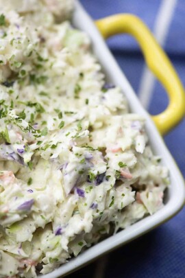 coleslaw dressing on cabbage in yellow bowl