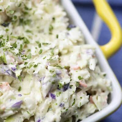 coleslaw dressing on cabbage in yellow bowl