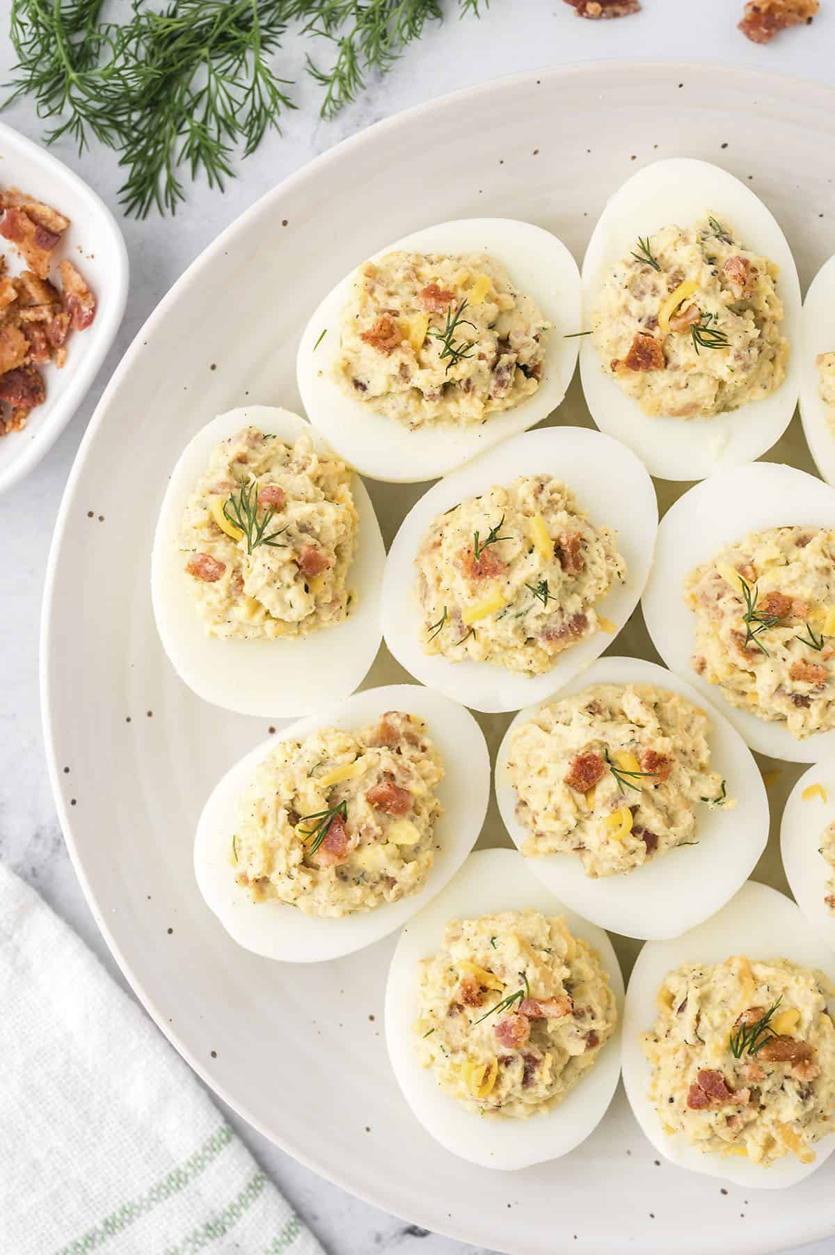 bacon deviled eggs recipe on serving platter.