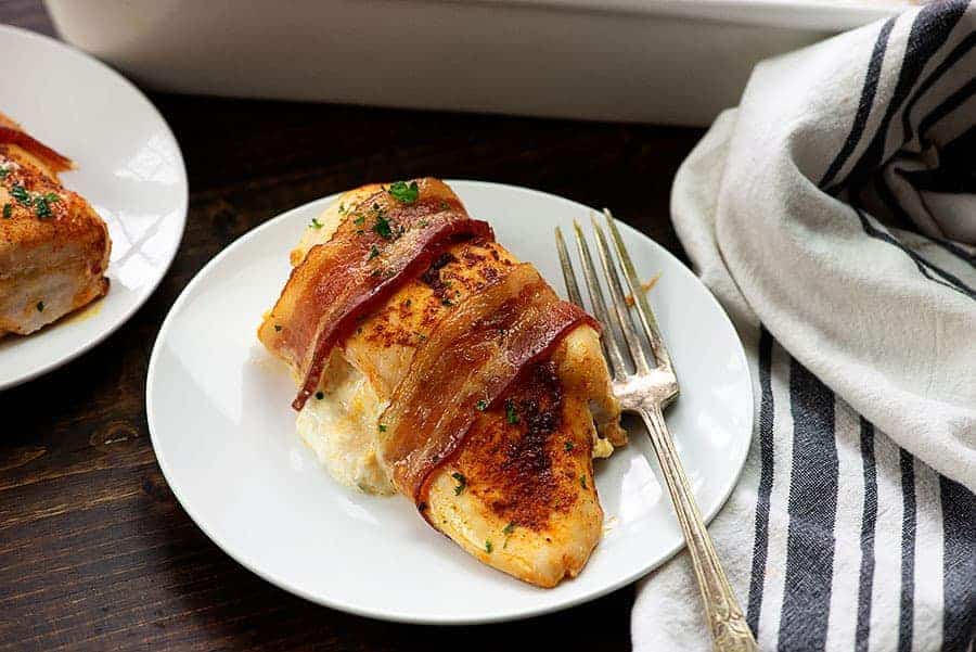 bacon wrapped chicken breast on white plate