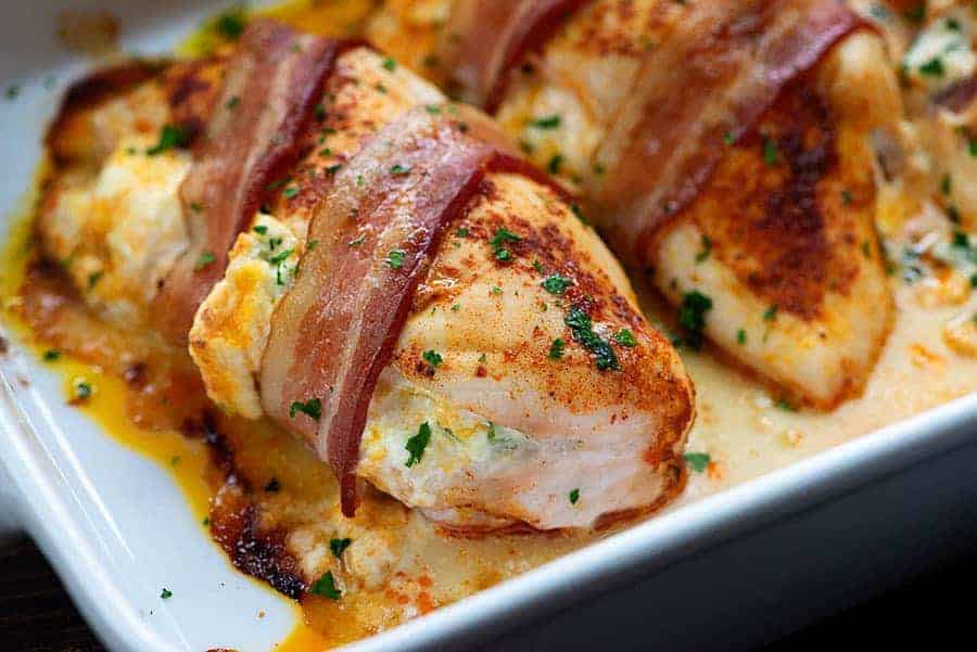bacon wrapped chicken in white baking dish