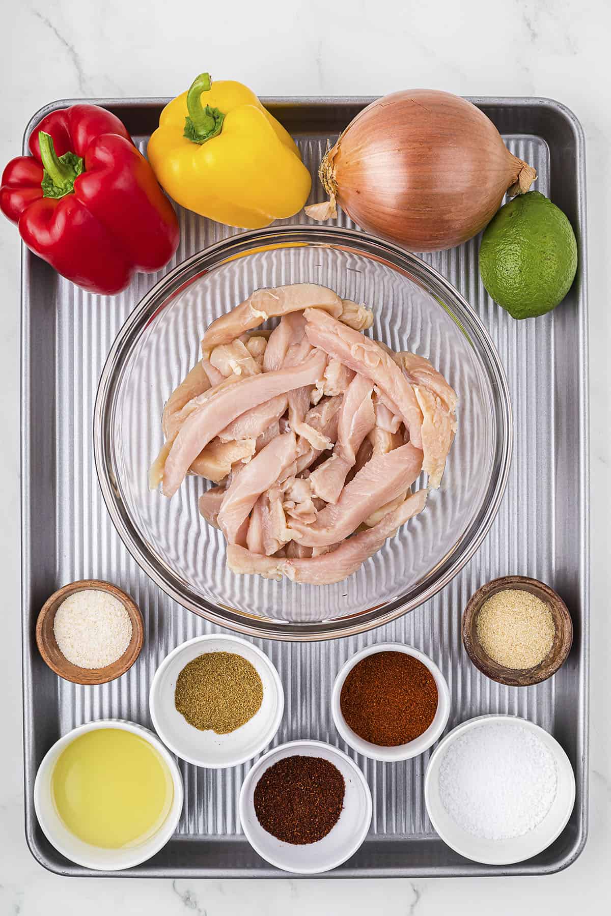 Ingredients for making sheet pan chicken fajitas.
