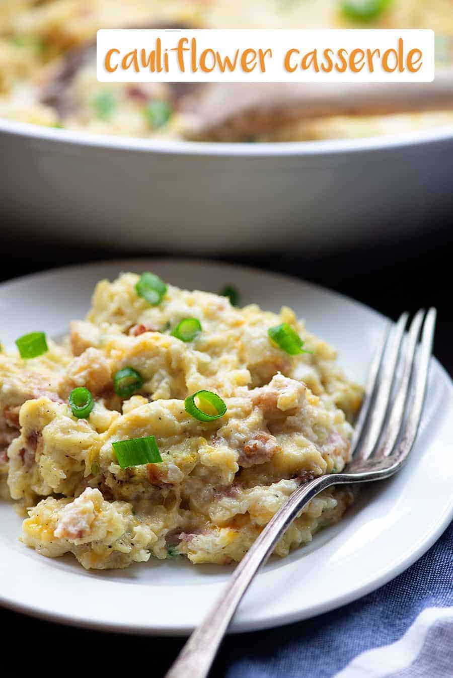 Cauliflower casserole on white plate with fork.