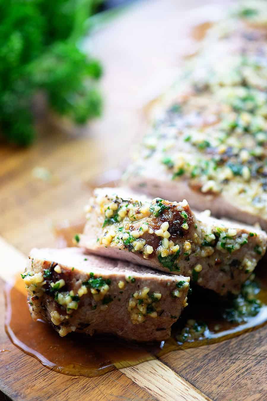 oven roasted pork tenderloin on wood cutting board