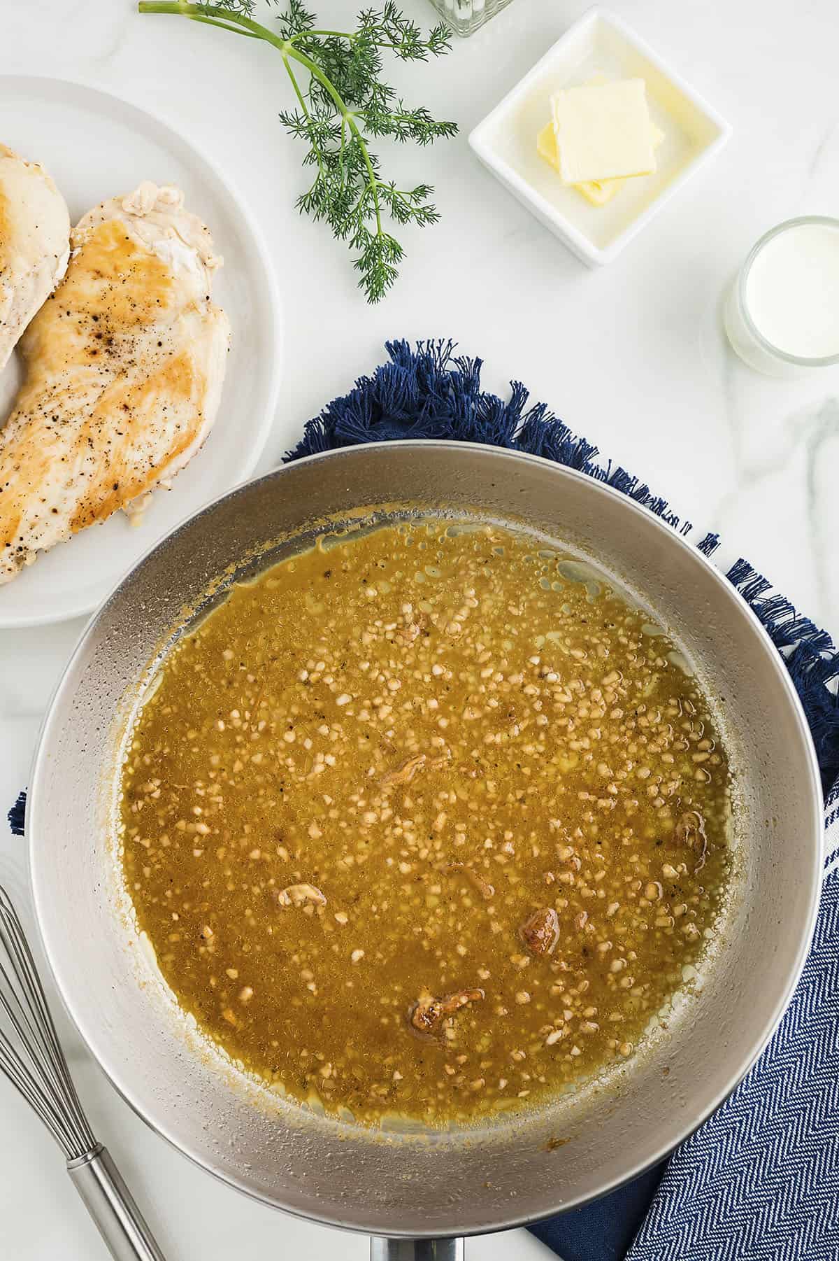 Garlic and broth in skillet.