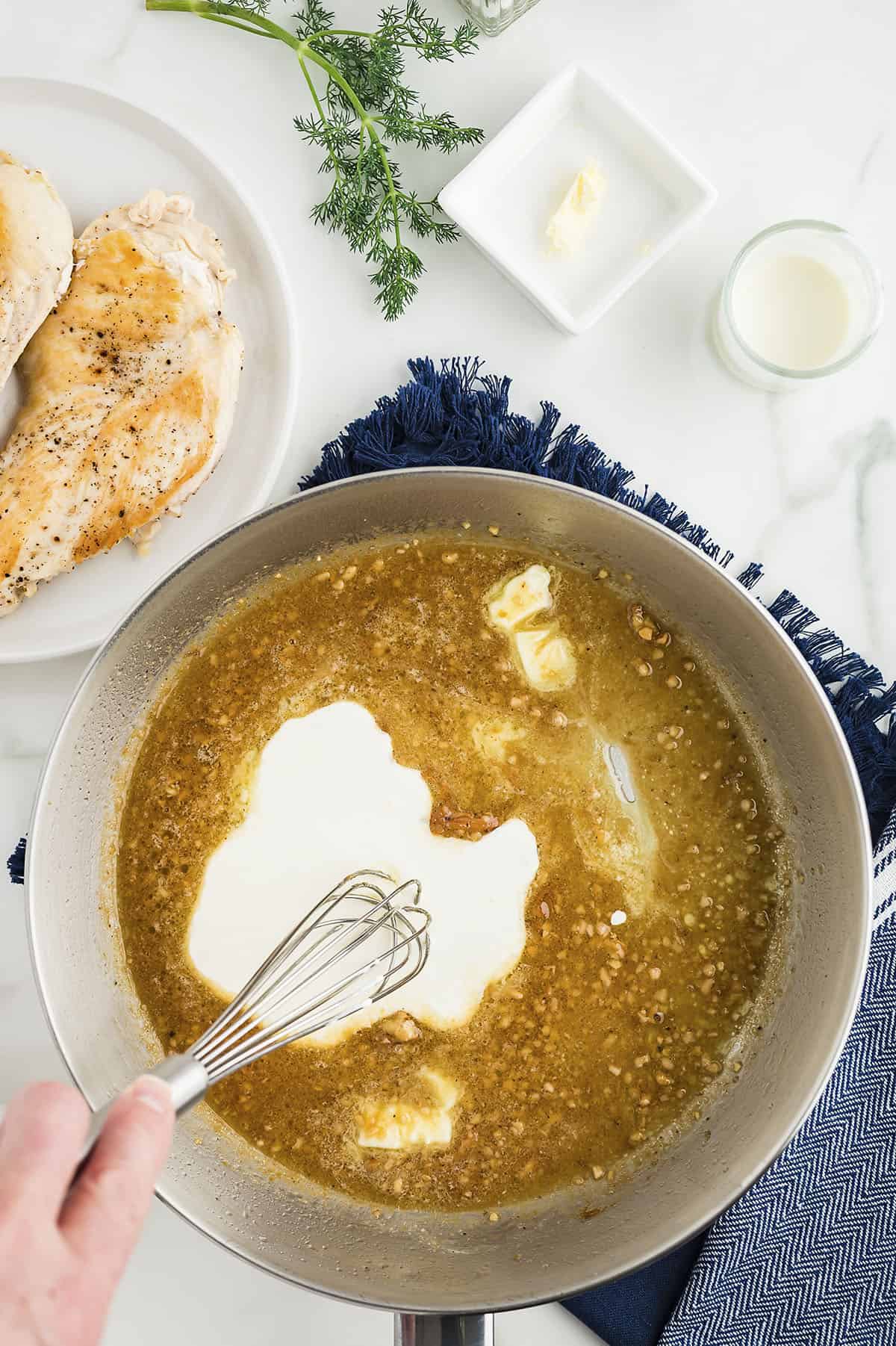 Cream and butter in skillet with broth.