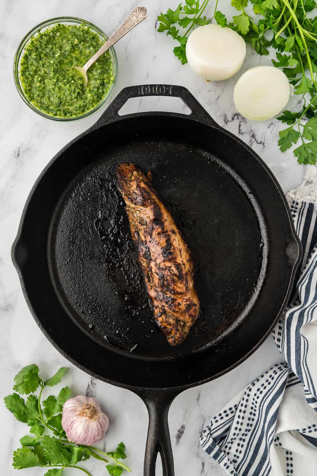 Baked pork tenderloin in cast iron skillet.