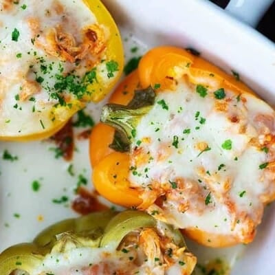 cheesy stuffed peppers in white baking dish