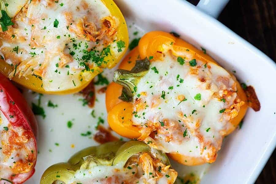 cheesy stuffed peppers in white baking dish