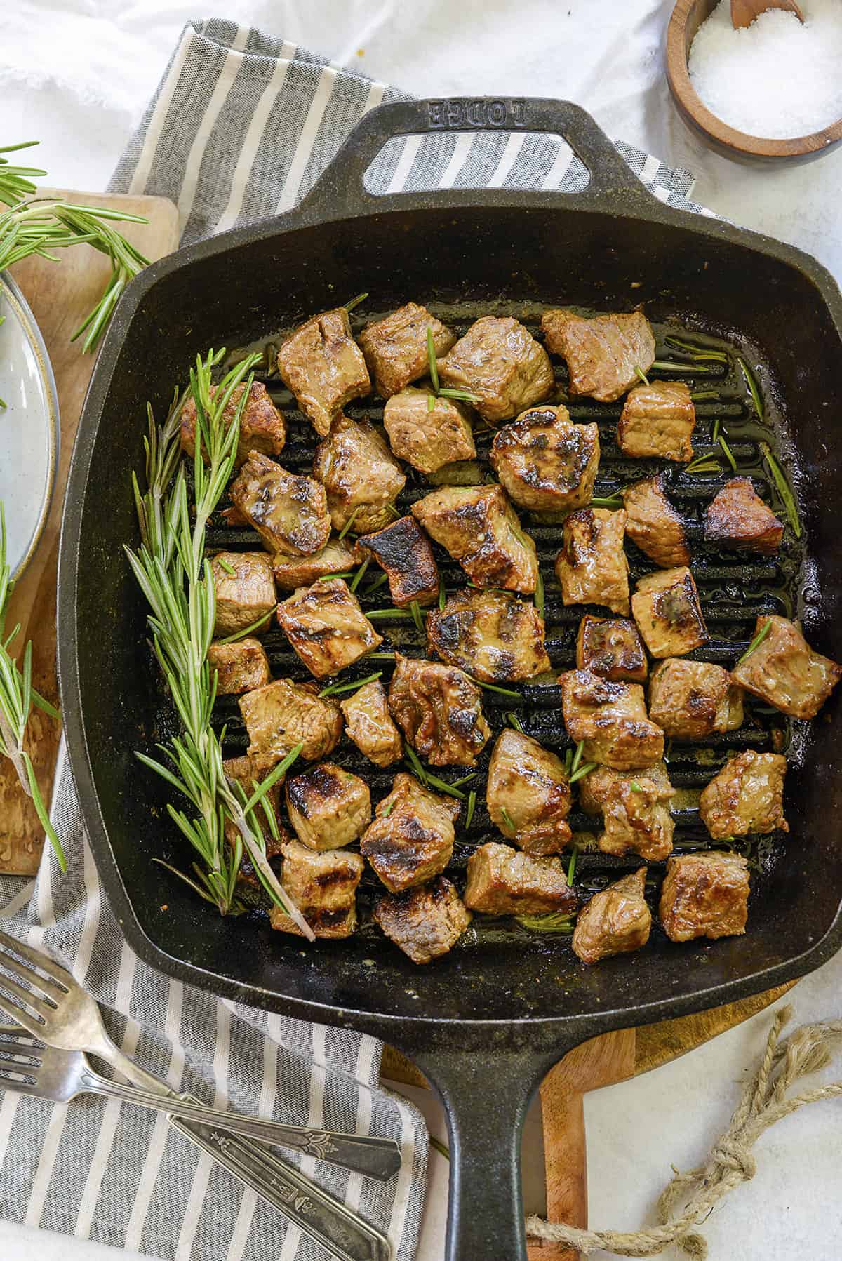 Cast iron skillet full of steak bites.