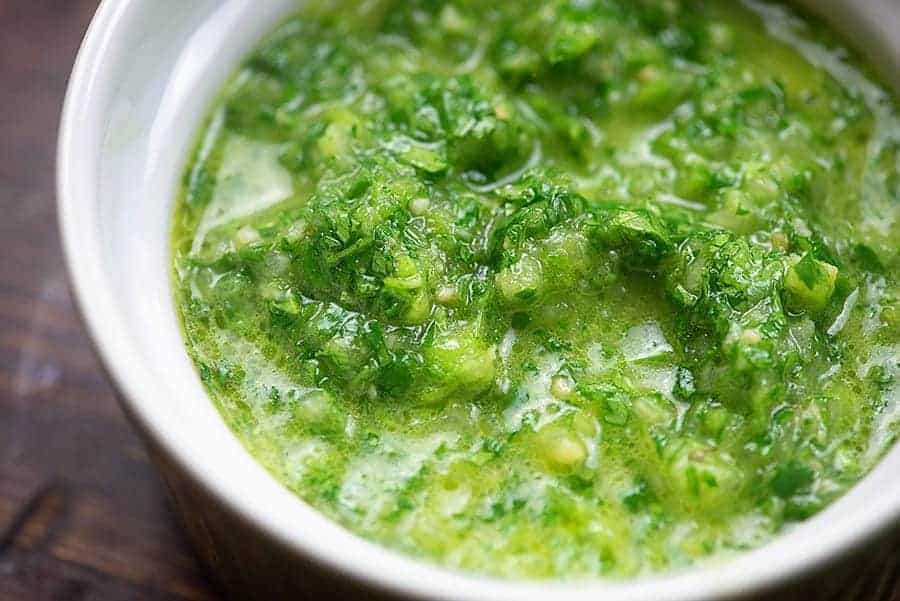 Chimichurri sauce in a white bowl.