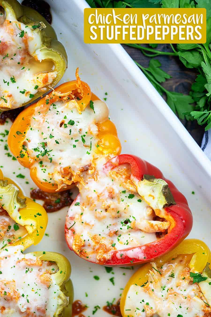 Stuffed peppers lined up in a white baking pan