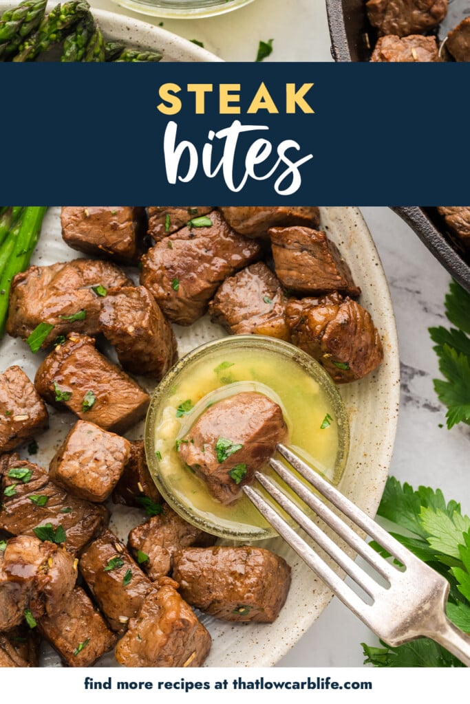 Steak bite being dippedi n garlic butter sauce.