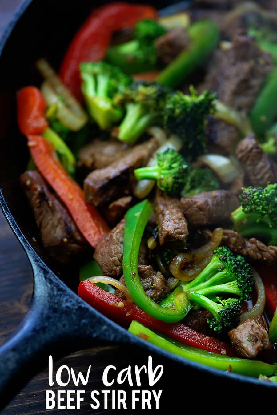 Beef stir fry cooking in a cast iron skillet.