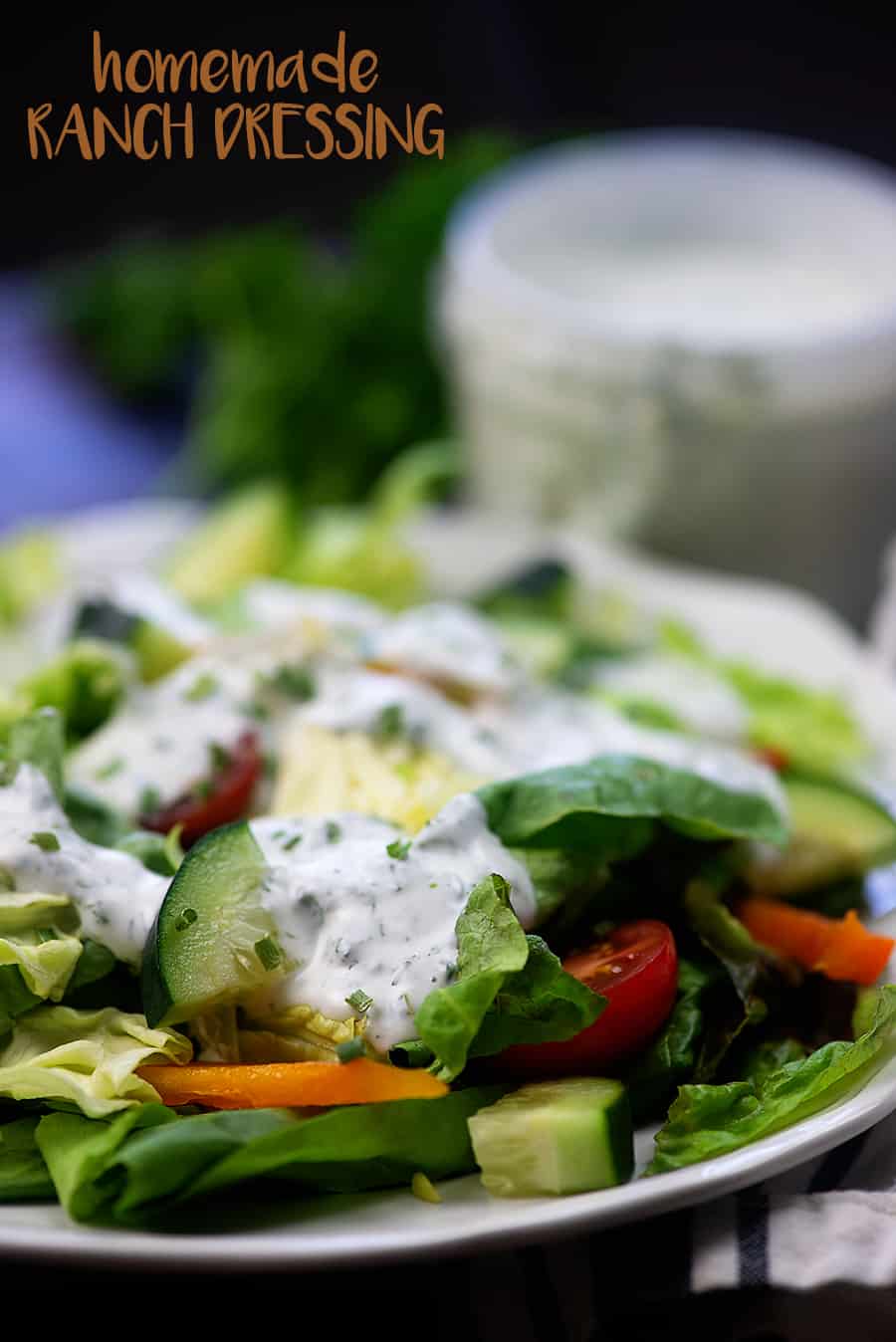 Salad on white plate with ranch dressing