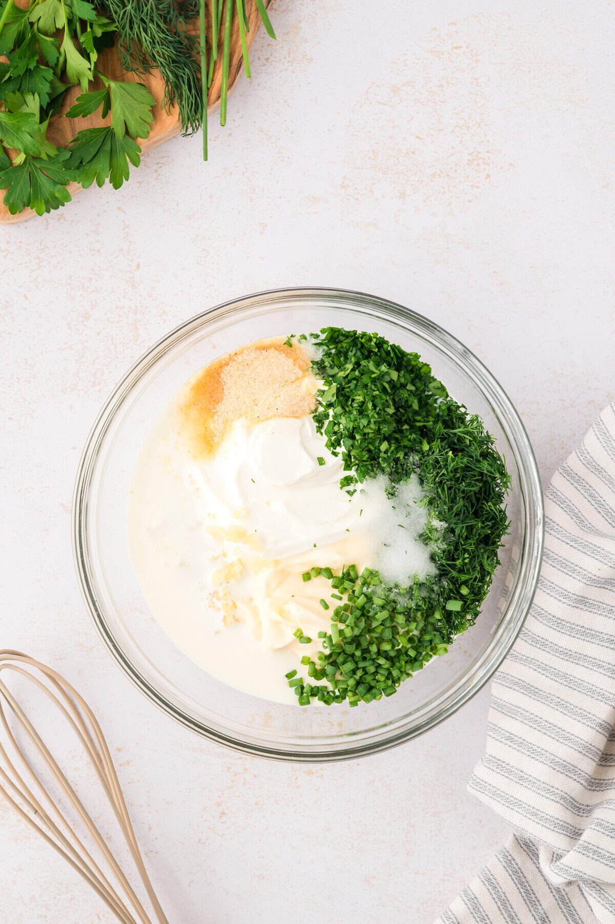 Ingredients for keto ranch dressing in glass mixing bowl.