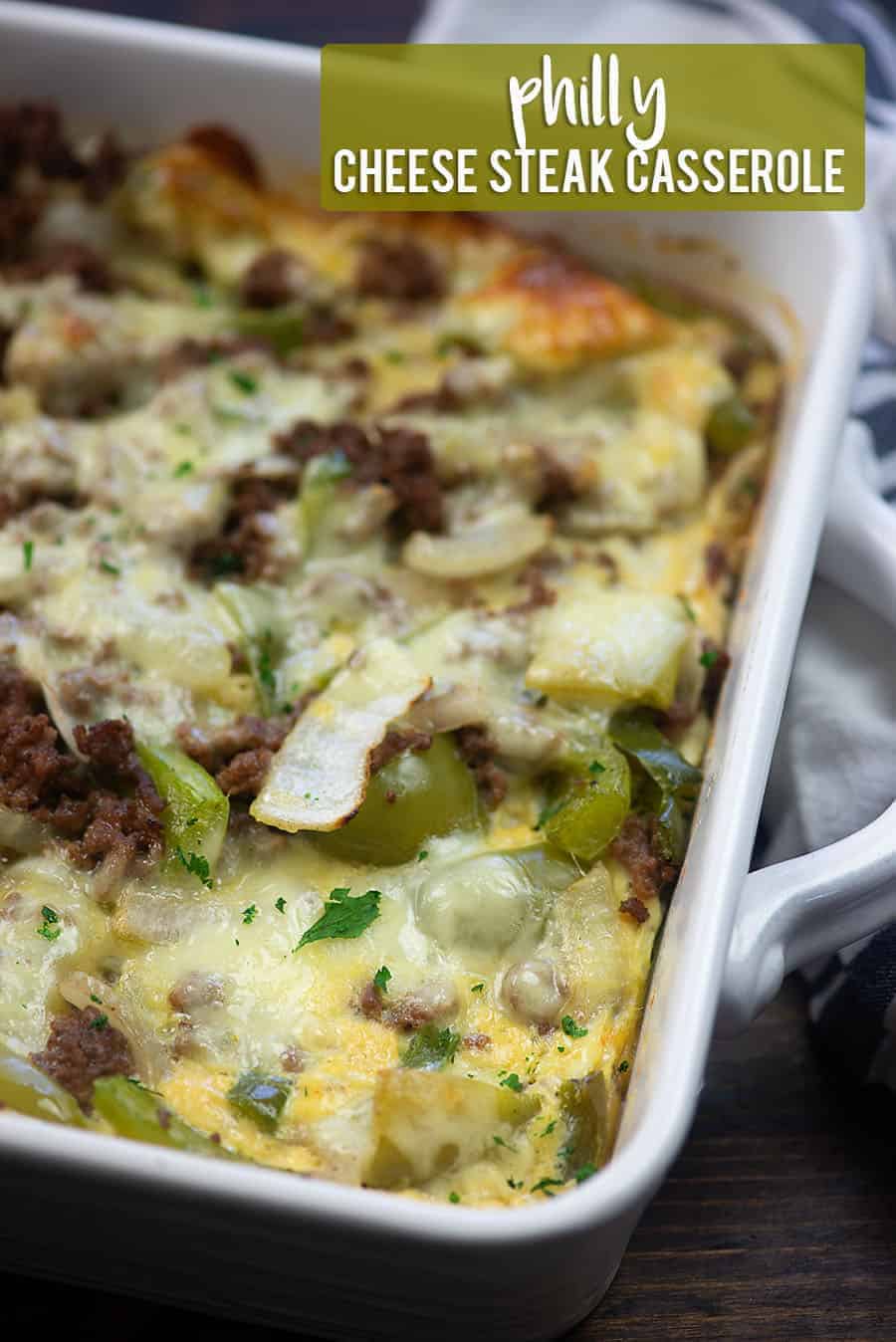 A close up of Philly cheesesteak casserole in a white baking pan