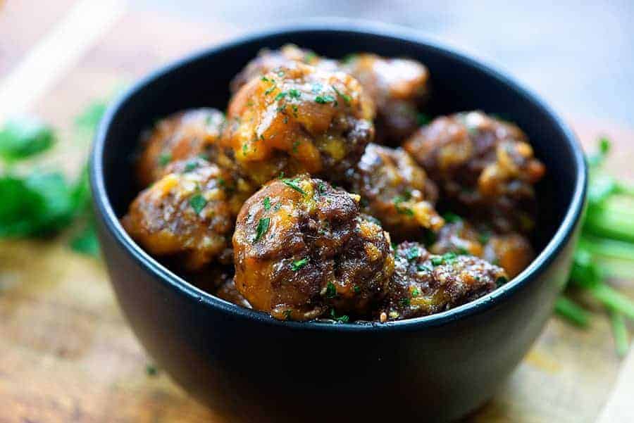 barbecue meatballs in black bowl