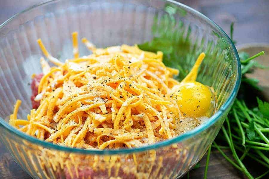 Ingredients for low carb meatballs in glass bowl