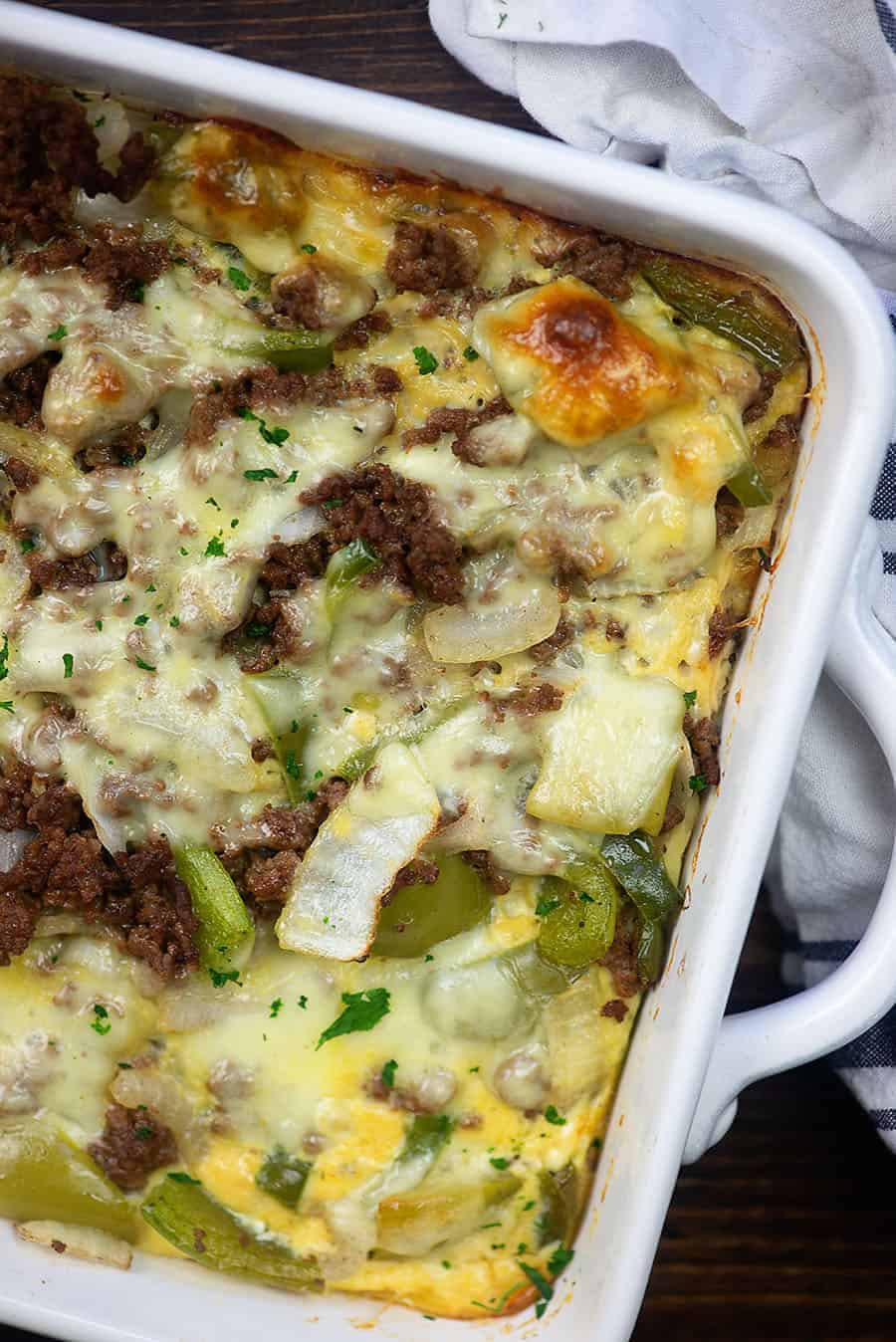 Philly cheesesteak casserole in a white baking pan
