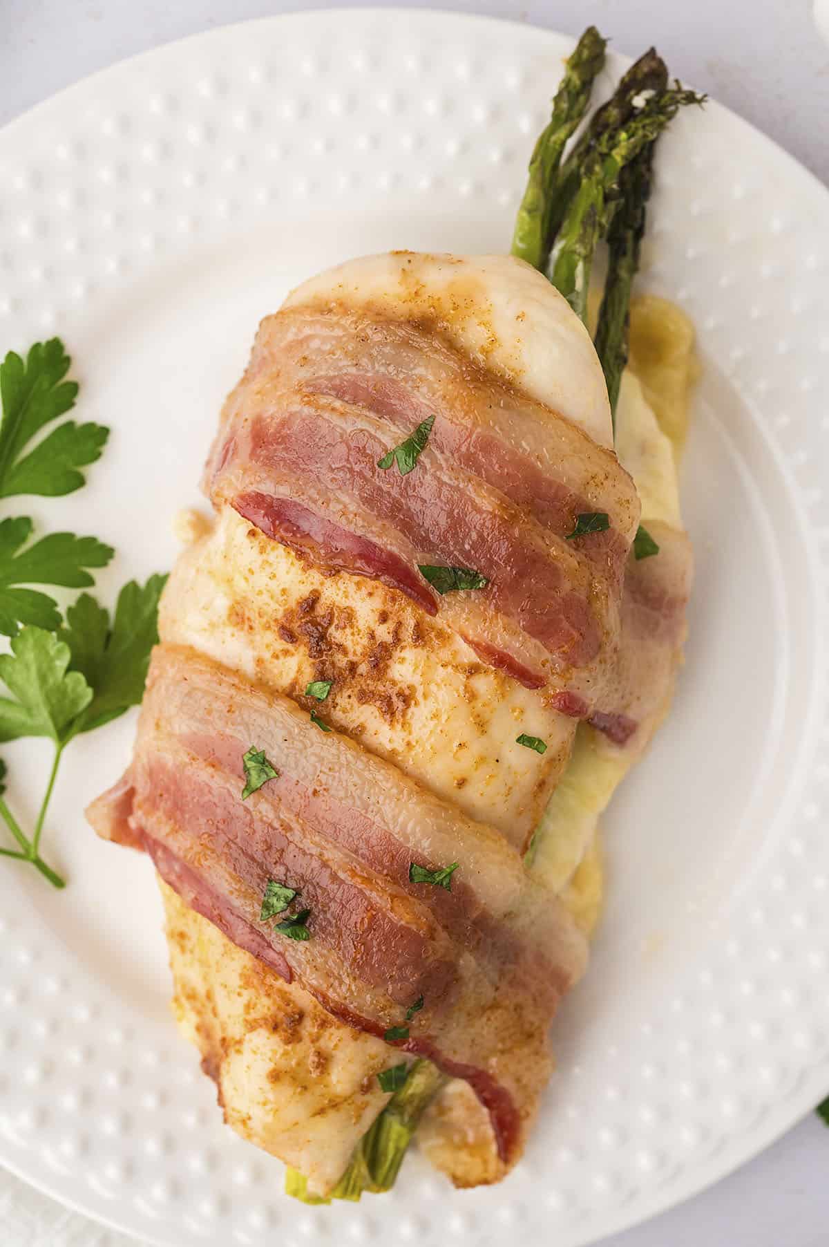 Chicken breast stuffed with asparagus and wrapped in bacon.