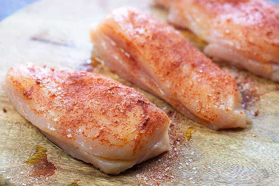 seasoned chicken on cutting board