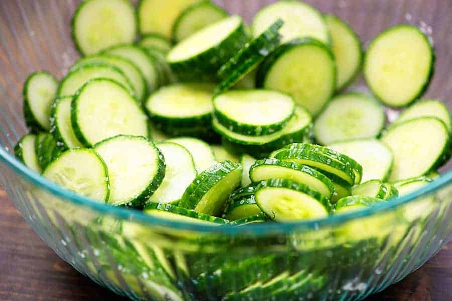 sliced cucumbers in glass bowl.