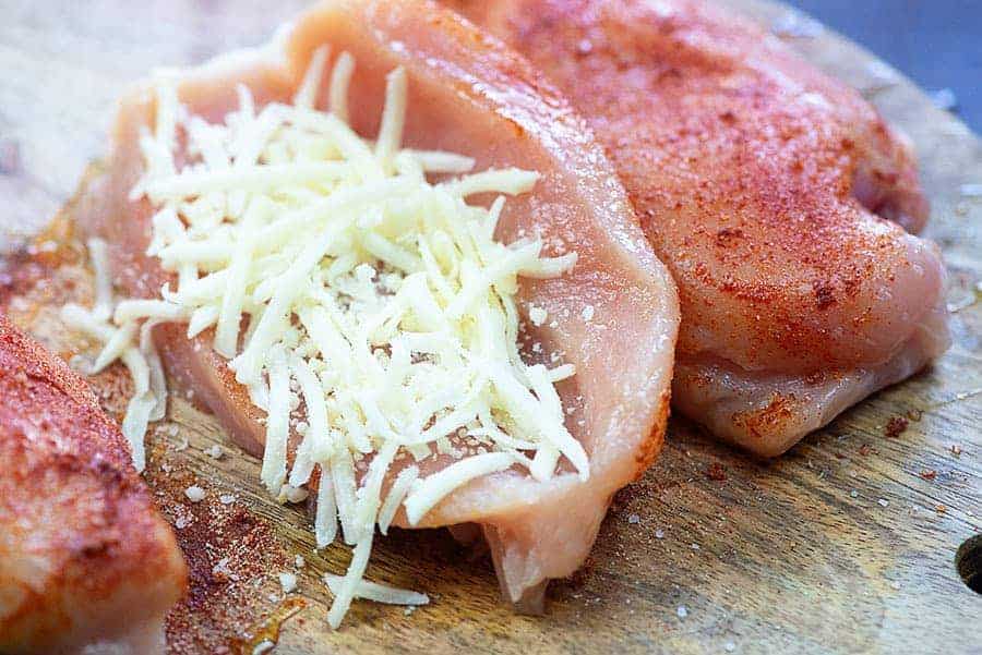 chicken breast stuffed with cheese on cutting board