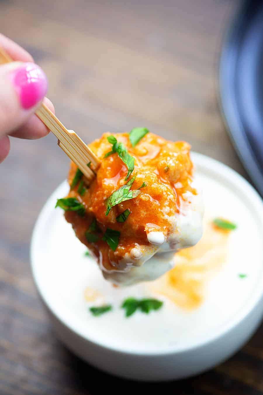 low carb chicken meatball on toothpick being dipped in ranch dressing