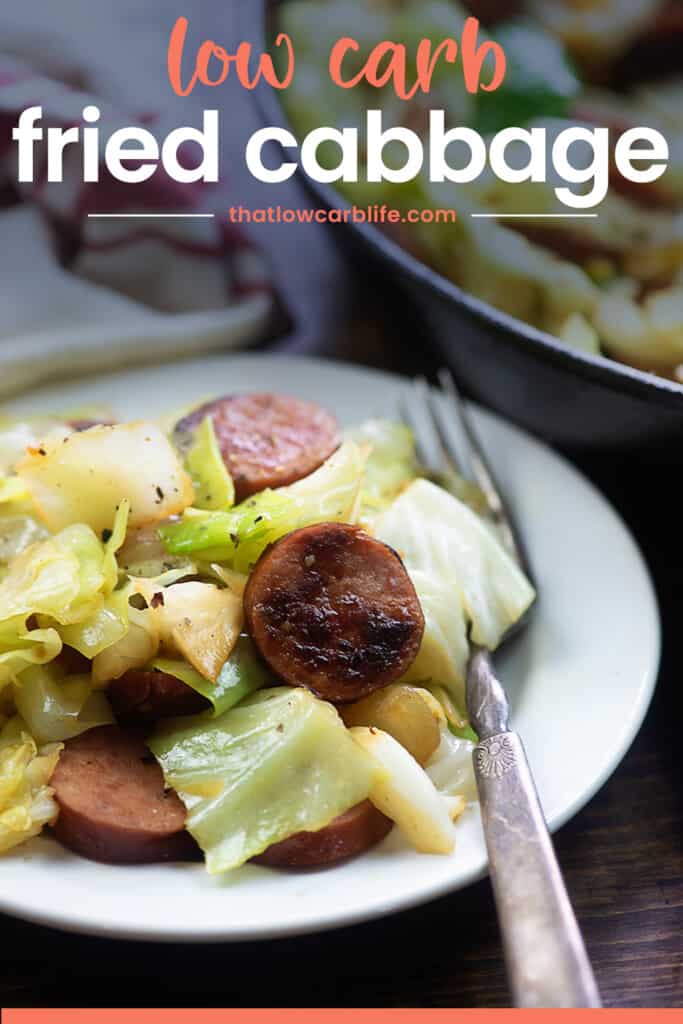 smoked sausage and cabbage on white plate.