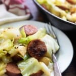 A plate full of food, with Cabbage and Sausage