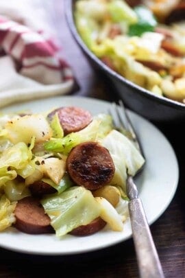 A plate full of food, with Cabbage and Sausage