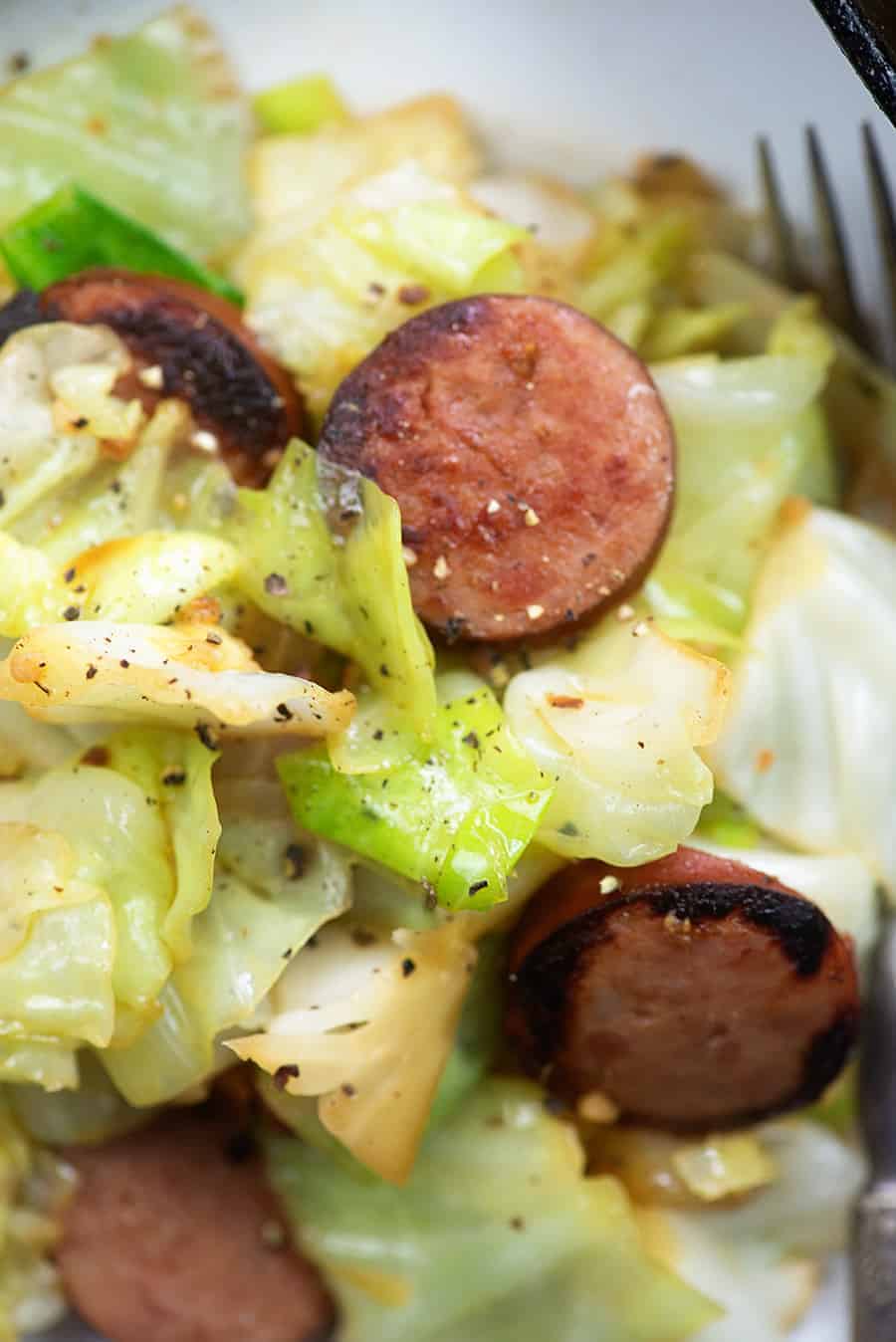 A close up of a plate of Cabbage and Sausage