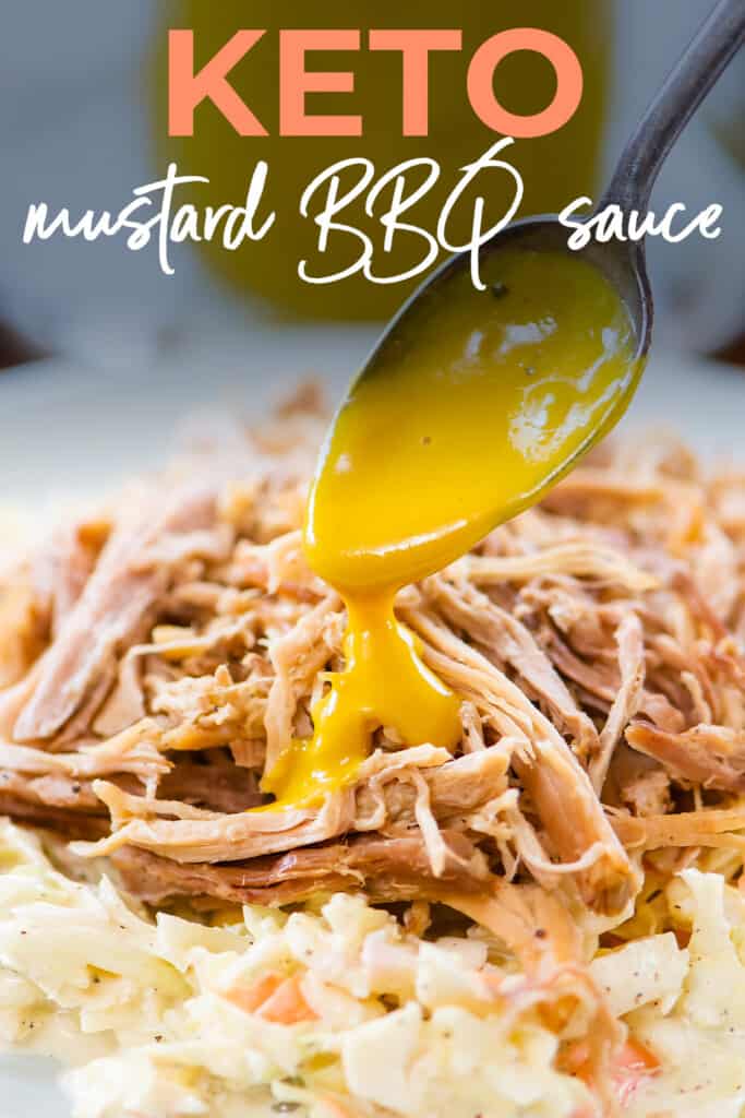 Mustard based bbq sauce on spoon over pulled pork.