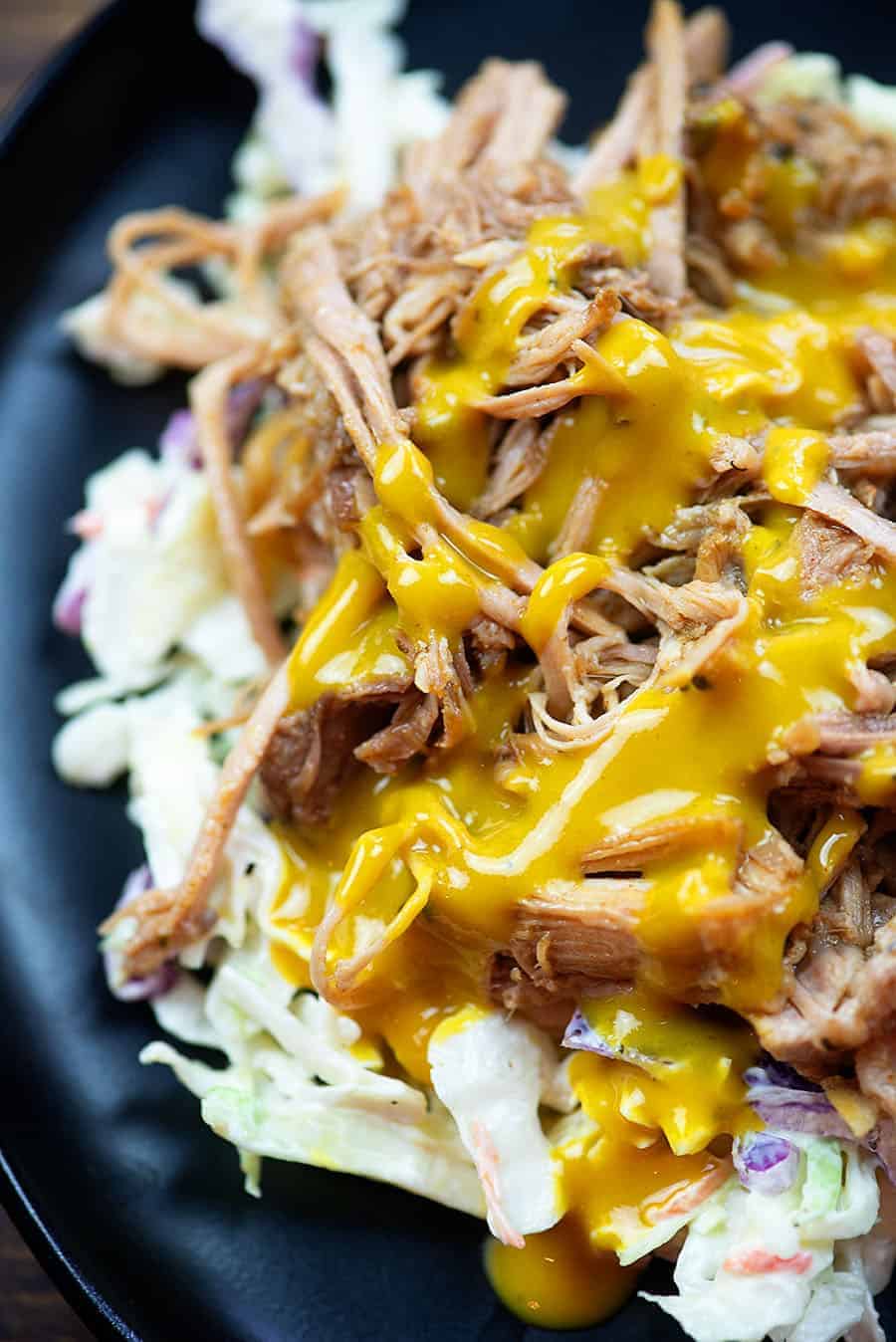 pulled pork and cole slaw on a black plate