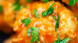 Low carb buffalo chicken meatballs! Bake these up and serve them as an appetizer or over mashed cauliflower for a main course. #footballfood #chicken #keto