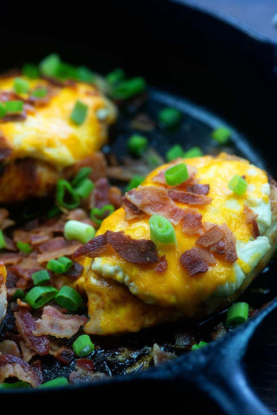 cheddar bacon chicken in a cast-iron skillet.
