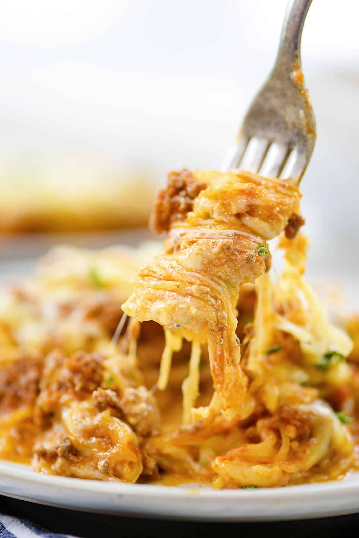 Spaghetti squash casserole twirled on a fork.