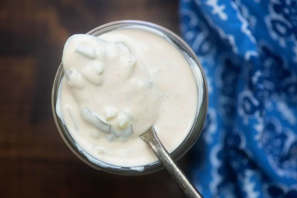 spoonful of thousand island dressing coming from a jar
