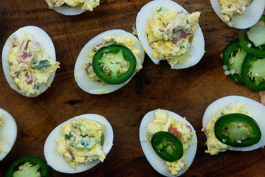 spicy deviled eggs on cutting board