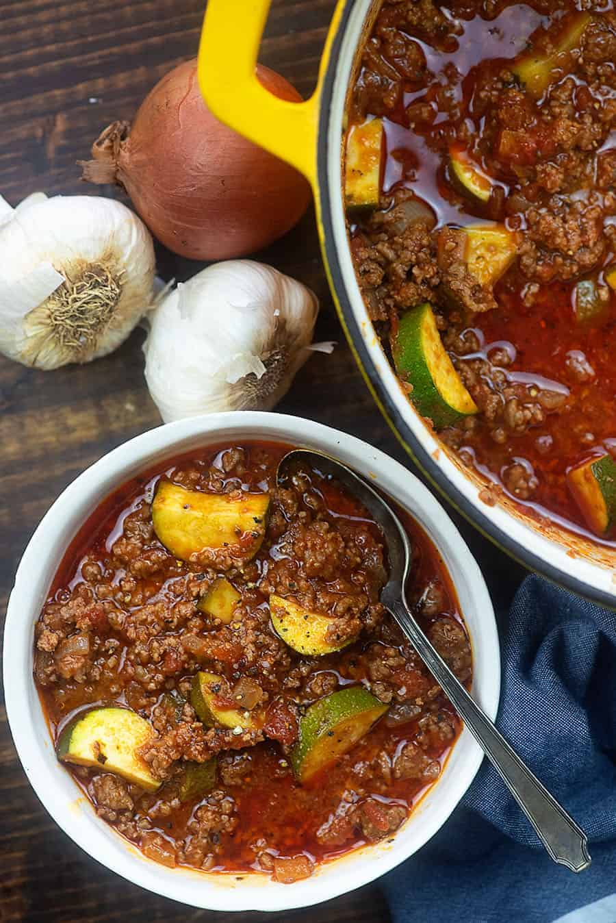 pot of goulash next to a bowl of goulash