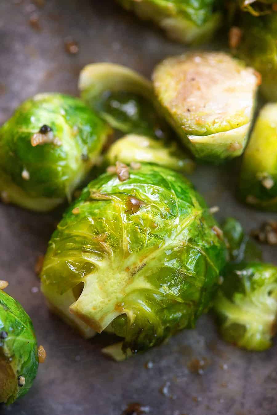 A close up of a cooked whole Brussel sprout.