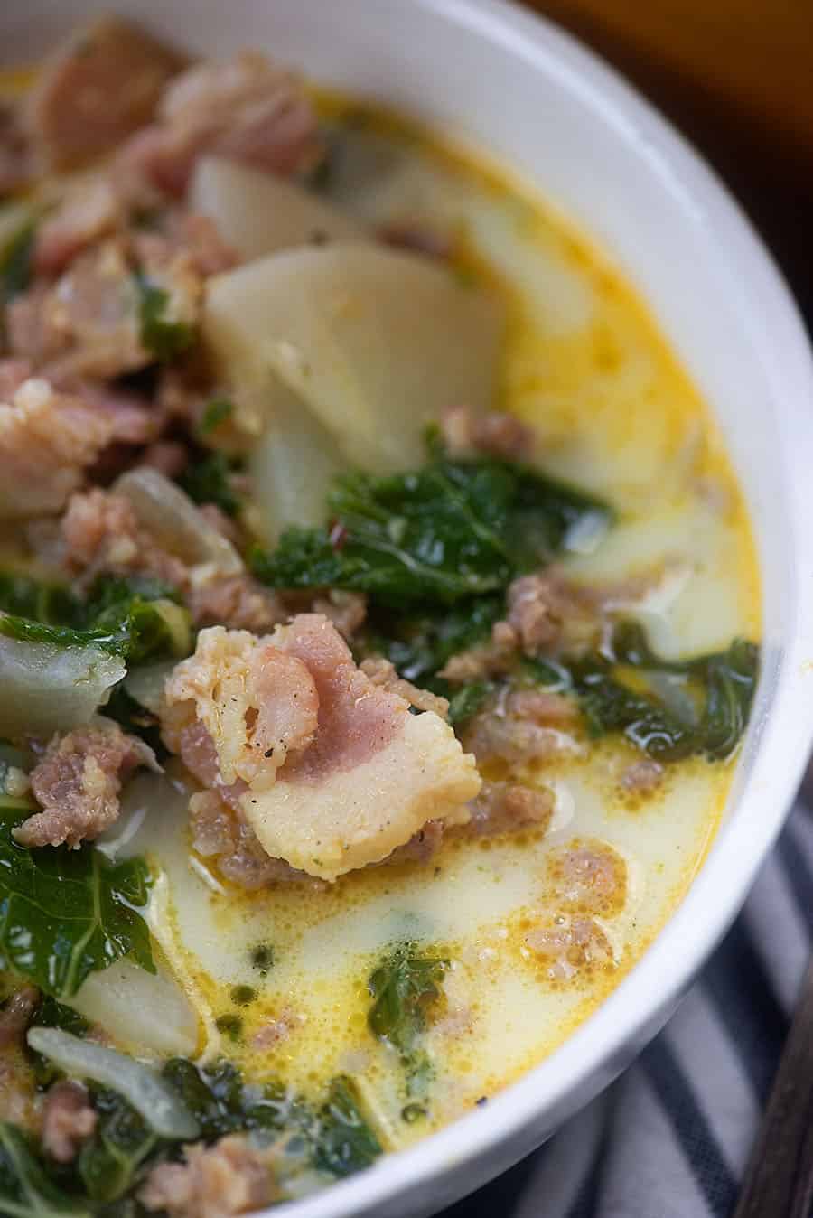 White bowl with zuppa toscana in it