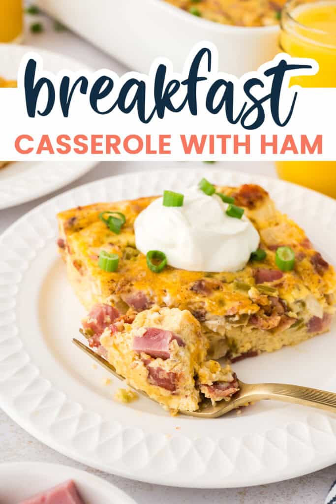 Breakfast casserole with ham on white plate.